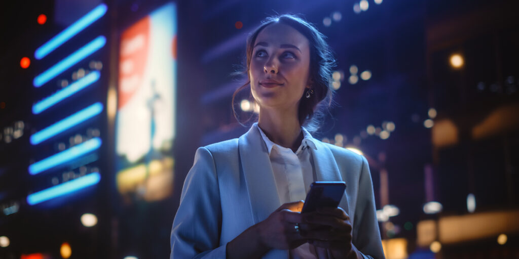 A women on a phone looking up