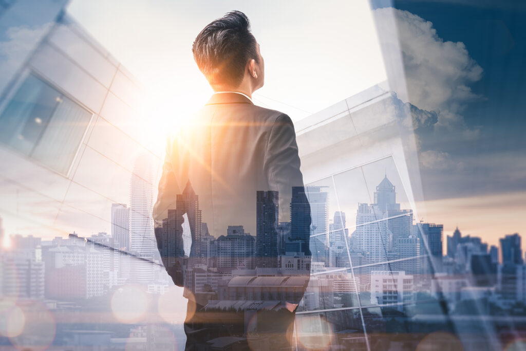 A man looking up with an overlay of a city skyline